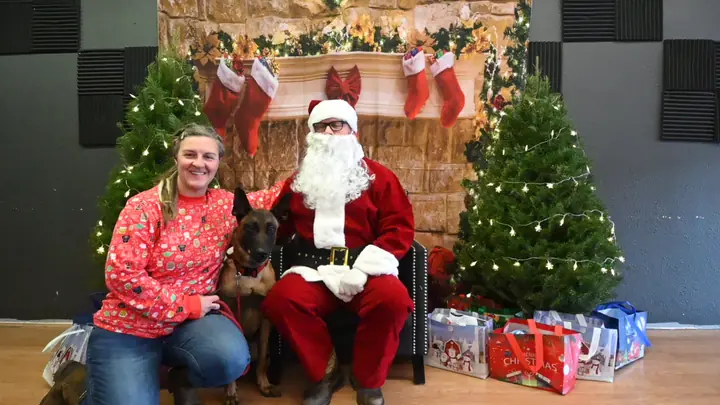 Client and dog posing for Santa photos with Jason Lake at Prodogz Dog Training in Medford, Oregon — December 18, 2022