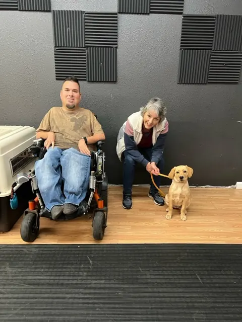 Clients and dogs in a Prodogz Dog Training puppy class led by Jason Lake in Medford, Oregon — December 16, 2022, photo 4